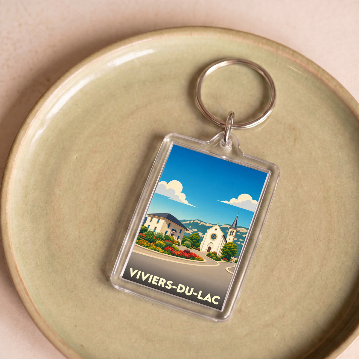 Porte-clés souvenir de la ville de Viviers-du-Lac avec une illustration stylisée.