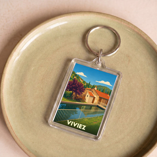Porte-clés souvenir de la ville de Viviez avec une illustration stylisée.