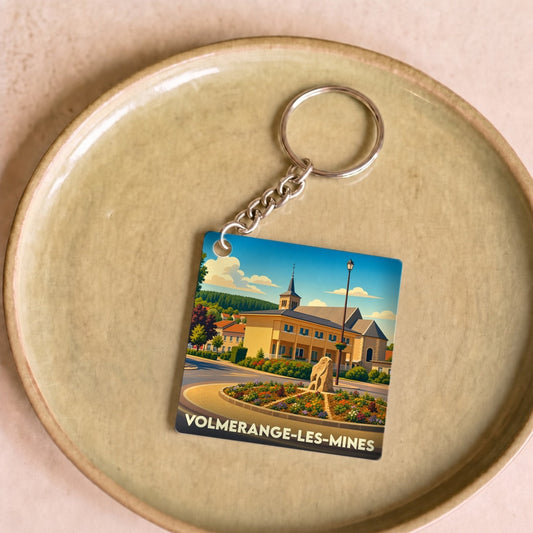 Porte-clés souvenir de la ville de Volmerange-les-Mines avec une illustration stylisée.