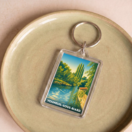 Porte-clés souvenir de la ville de Vouneuil-sous-Biard avec une illustration paysagère stylisée.