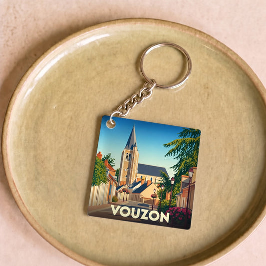 Porte-clés souvenir de la ville de Vouzon avec une illustration stylisée.