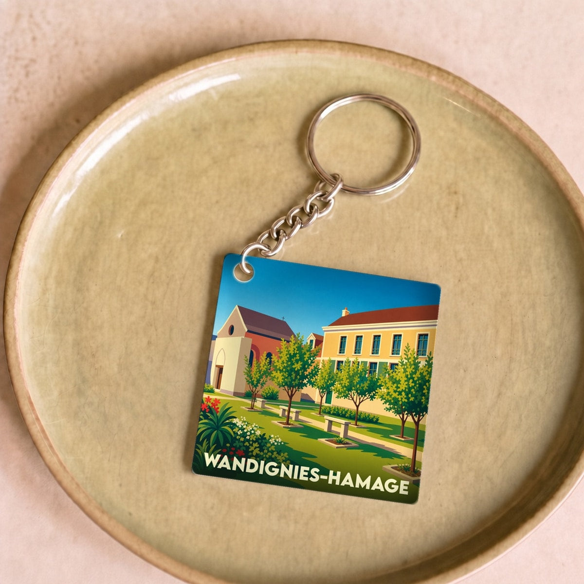 Porte-clés souvenir de la ville de Wandignies-Hamage avec une illustration stylisée.