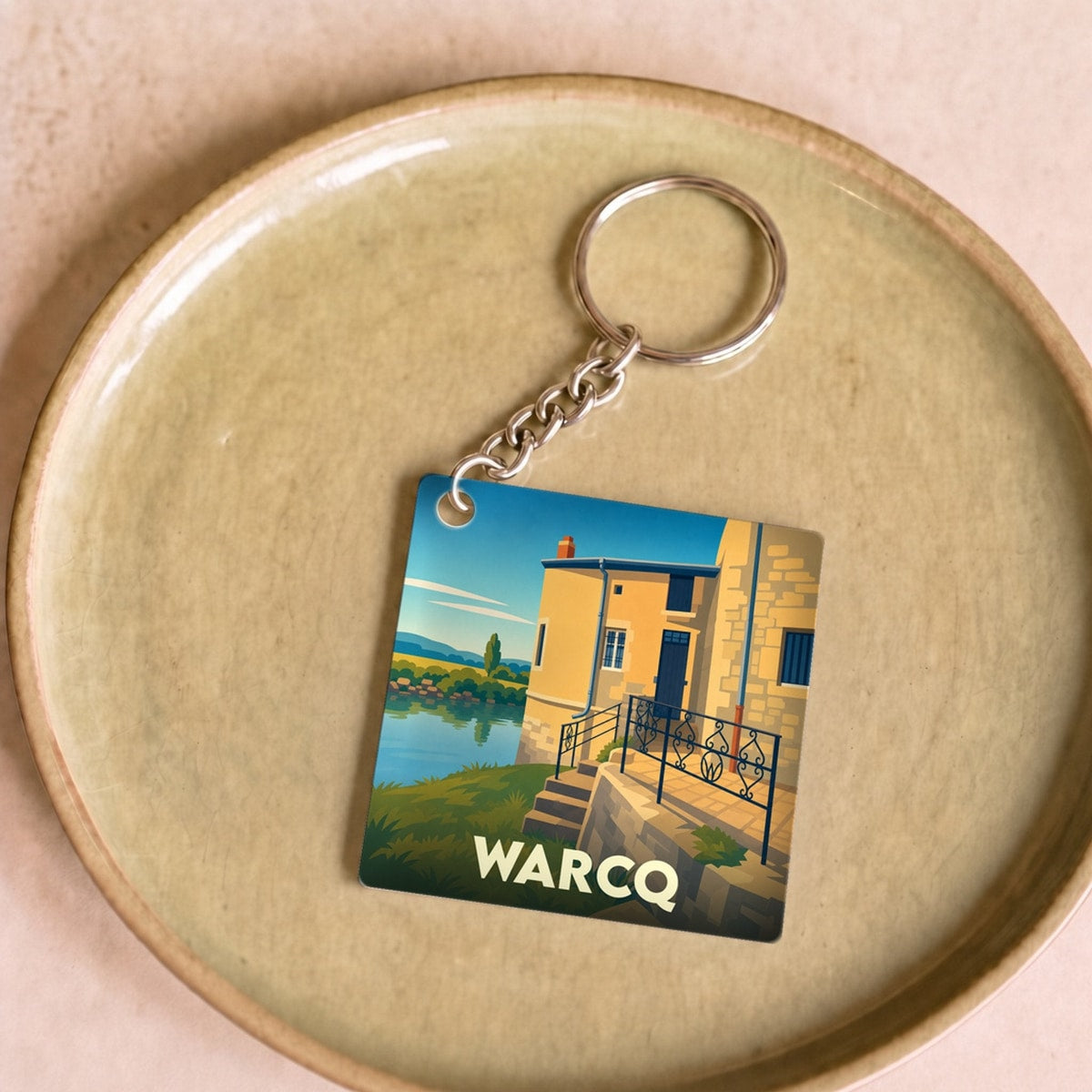 Porte-clés souvenir de la ville de Warcq avec une illustration stylisée.