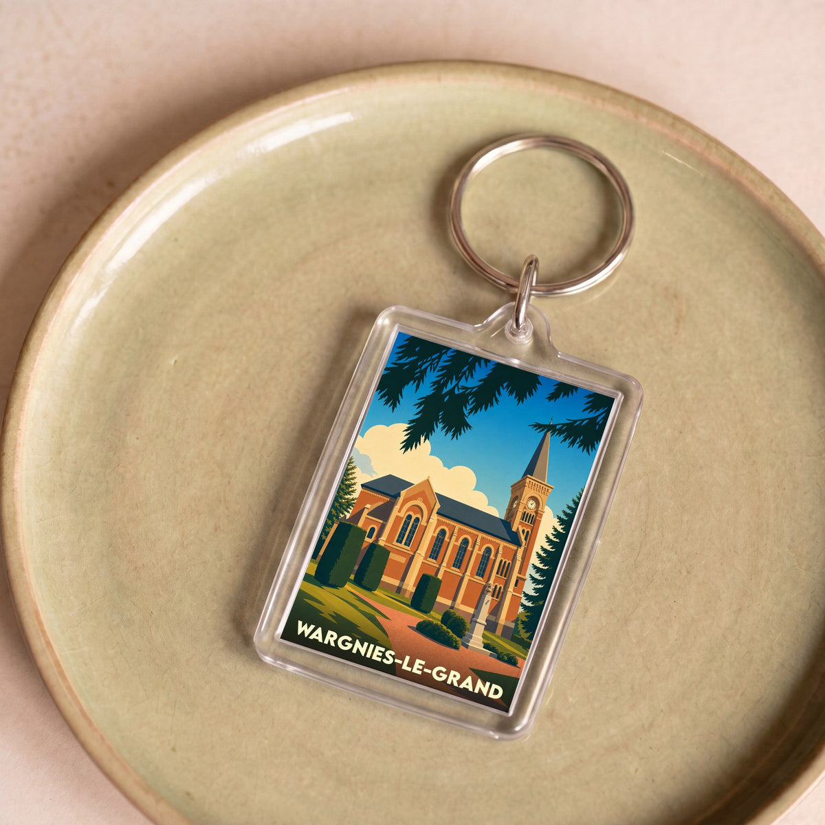 Porte-clés souvenir de la ville de Wargnies-le-Grand avec une illustration stylisée de son église.