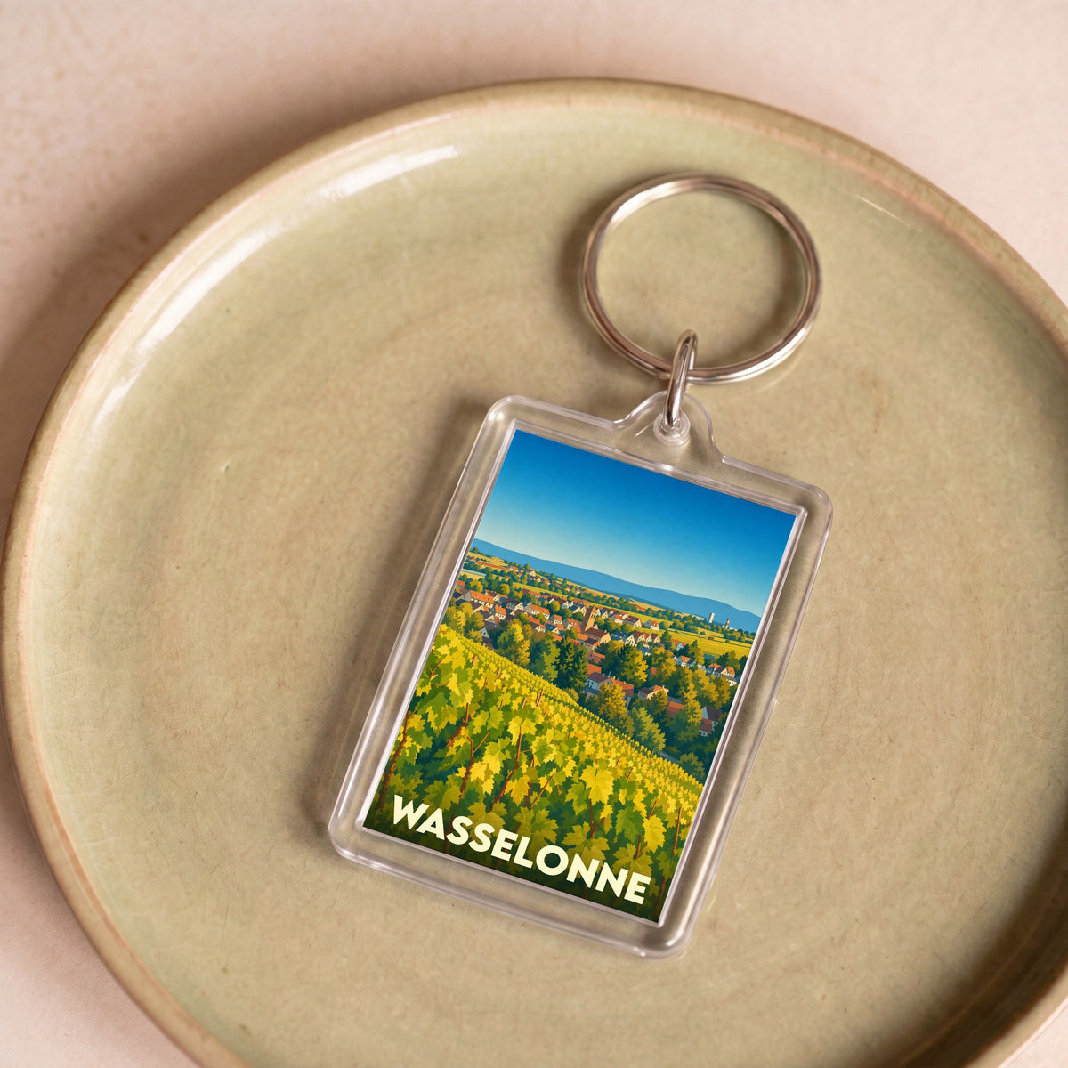 Porte-clés souvenir de la ville de Wasselonne avec une illustration stylisée de son vignoble.