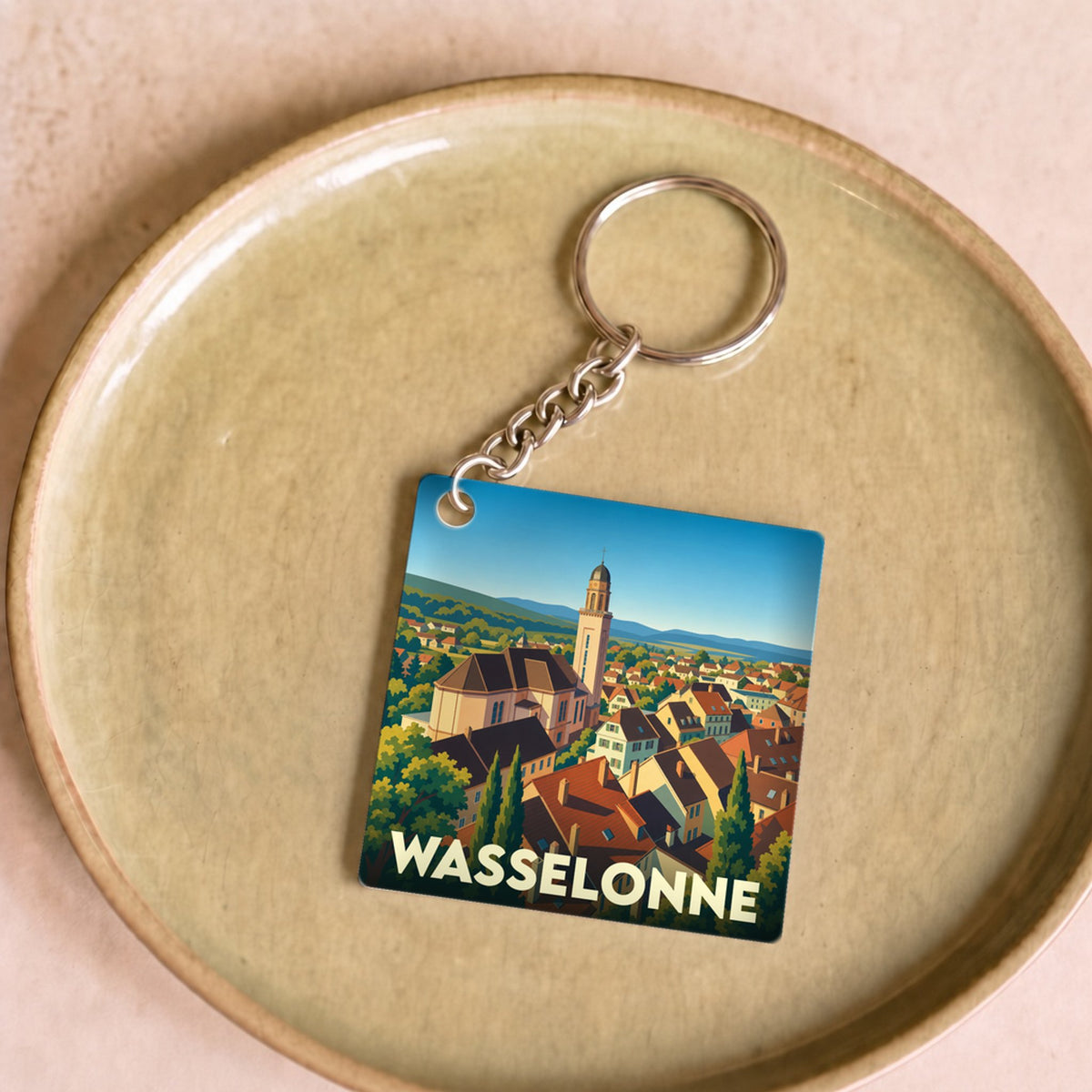 Porte-clés souvenir de la ville de Wasselonne avec une illustration stylisée de ses toits et de son église.