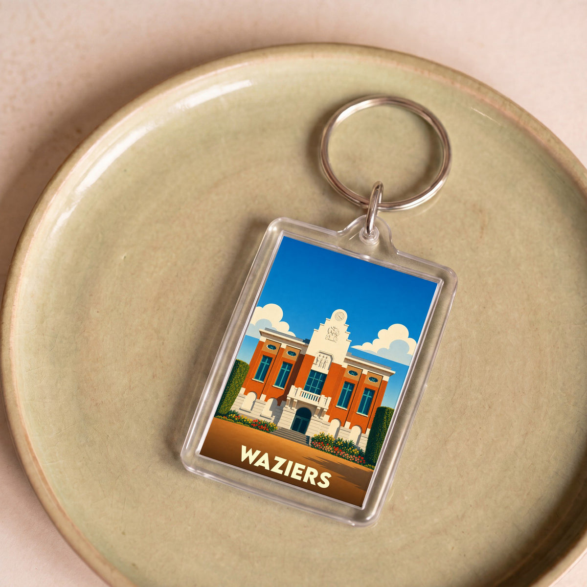 Porte-clés souvenir de la ville de Waziers avec une illustration stylisée de son hôtel de ville.