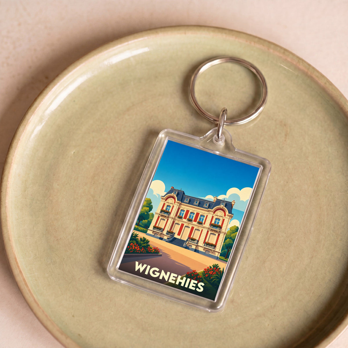 Porte-clés souvenir de la ville de Wignehies avec une illustration stylisée.