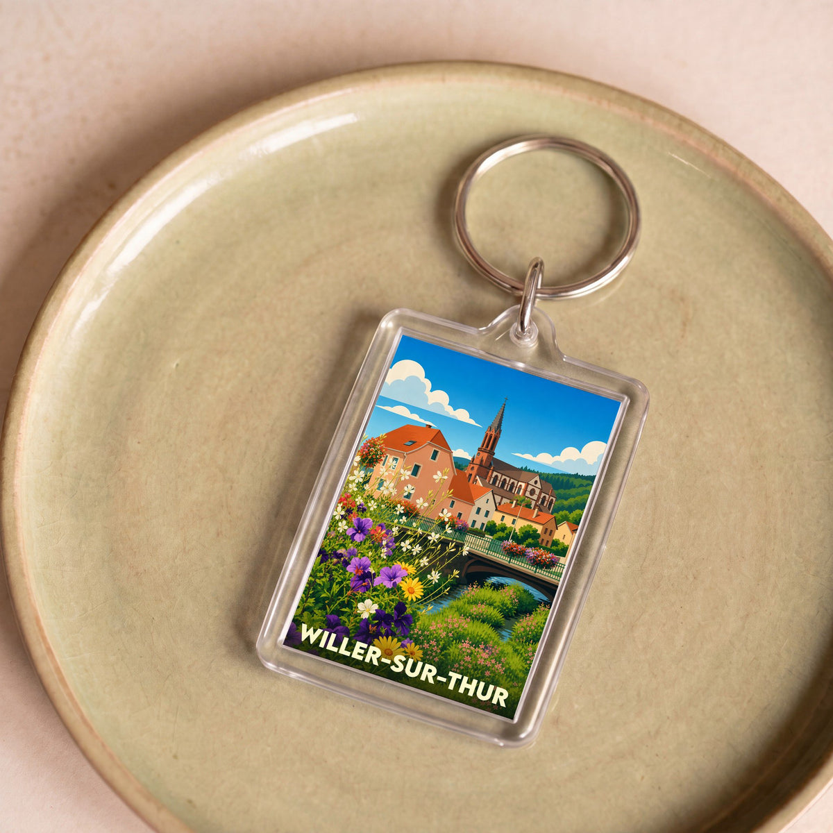 Porte-clés souvenir de la ville de Willer-sur-Thur avec une illustration stylisée et colorée.