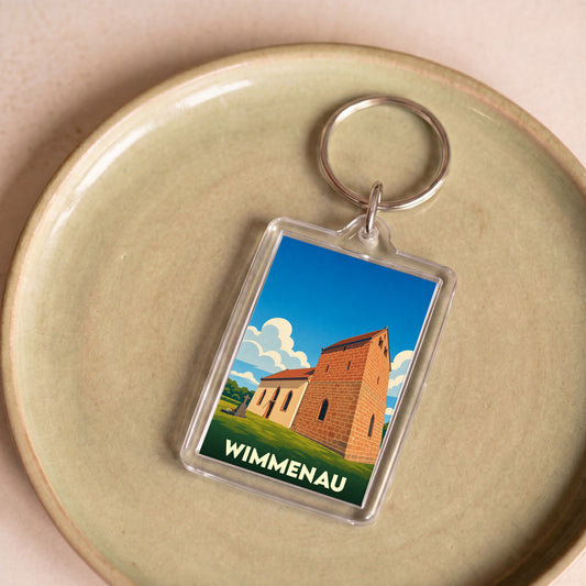 Porte-clés souvenir de la ville de Wimmenau avec une illustration stylisée d'une église sur fond de ciel bleu.