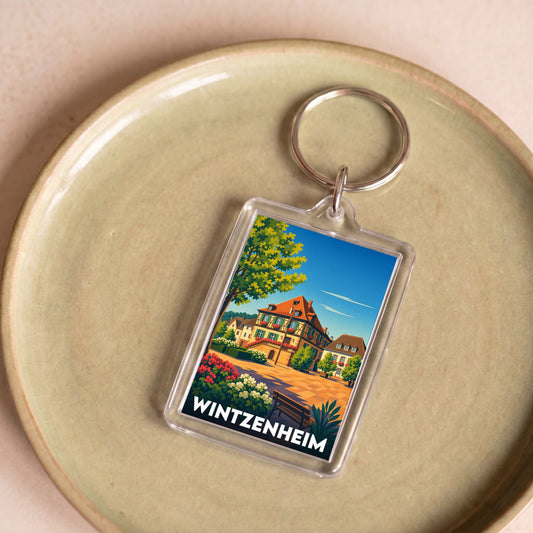 Porte-clés souvenir de la ville de Wintzenheim avec une illustration stylisée de maisons traditionnelles alsaciennes.