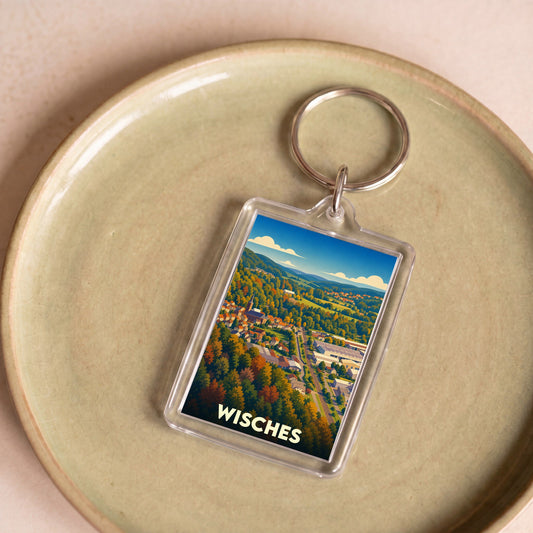 Porte-clés souvenir de la ville de Wisches avec une illustration stylisée de son paysage.