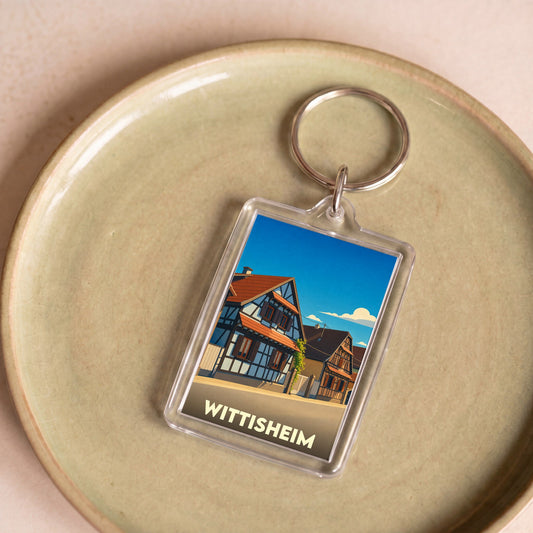 Porte-clés souvenir de la ville de Wittisheim avec une illustration stylisée de maisons à colombages.
