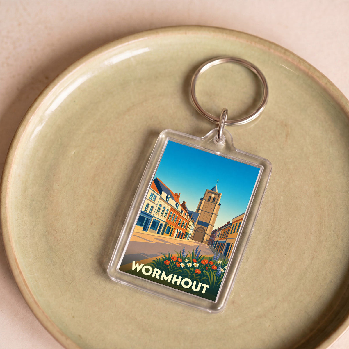 Porte-clés souvenir de la ville de Wormhout avec une illustration stylisée.