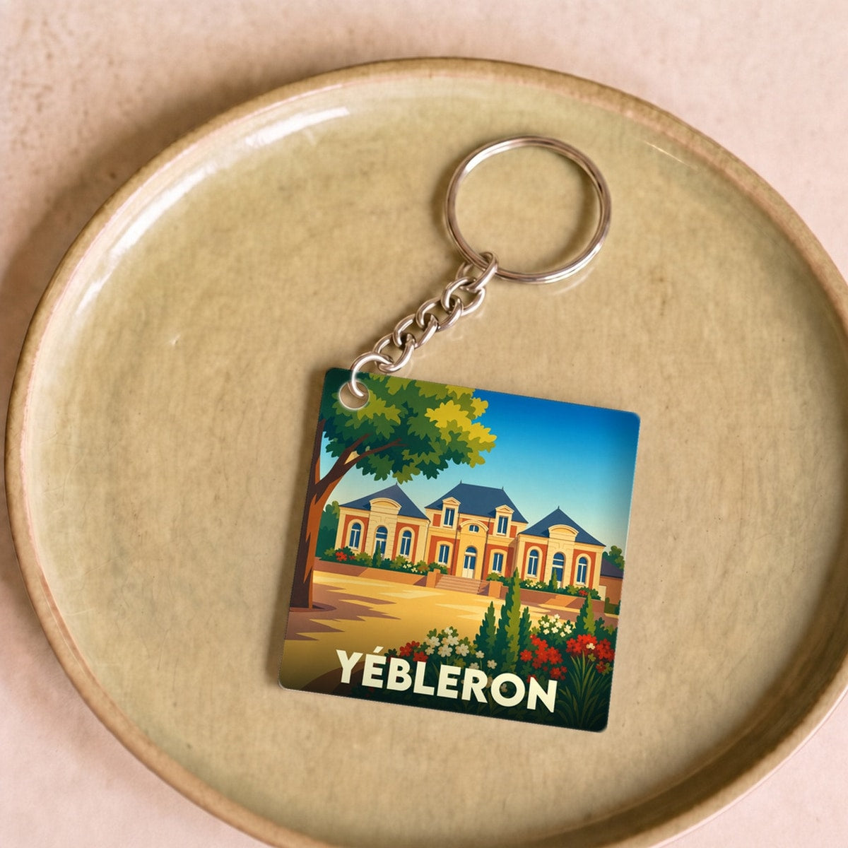 Porte-clés souvenir de la ville de Yébleron avec une illustration stylisée d'un château.