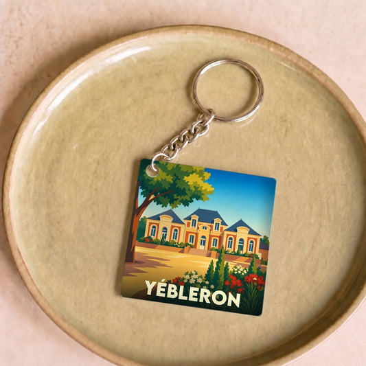 Porte-clés souvenir de la ville de Yébleron avec une illustration stylisée d'un château.