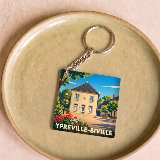 Porte-clés souvenir de la ville d'Ypreville-Biville avec une illustration stylisée d'une maison de village.