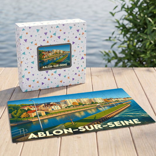 Puzzle souvenir de la ville d'Ablon-sur-Seine avec son boîtier, présentant une illustration stylisée des bords de Seine.