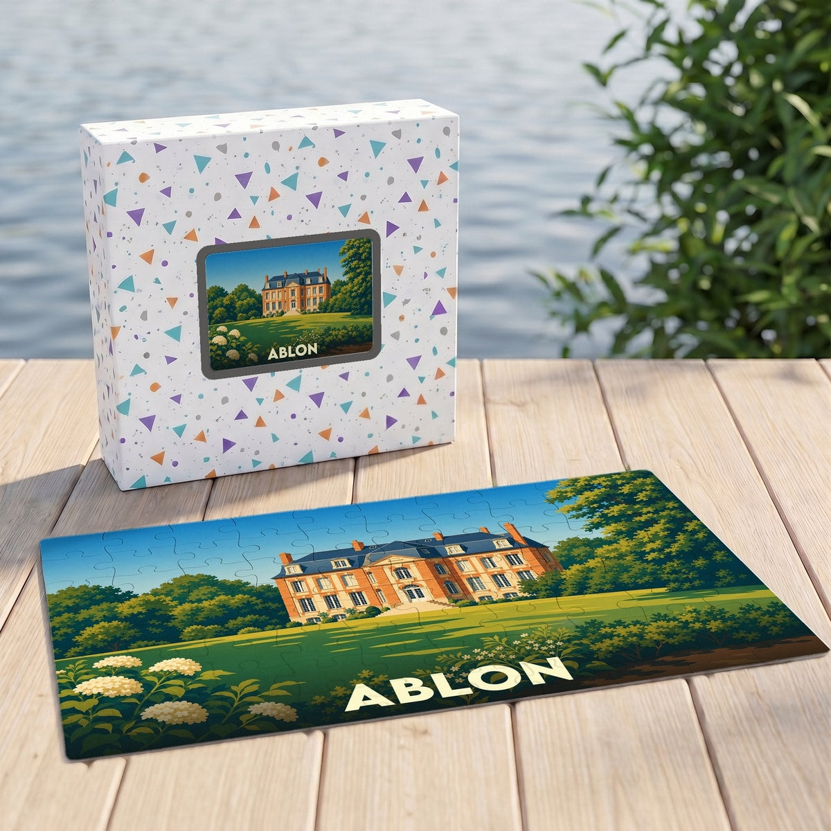 Puzzle souvenir de la ville d'Ablon illustrant un manoir historique sur une pelouse ensoleillée.