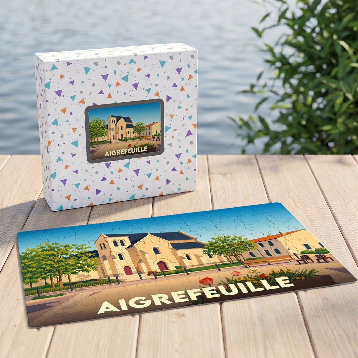 Puzzle souvenir de la ville d'Aigrefeuille illustrant une église de style rétro sur une terrasse en bois.