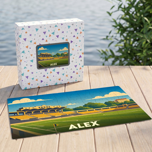 Puzzle souvenir de la ville d'Alex représentant un stade avec une illustration stylisée.