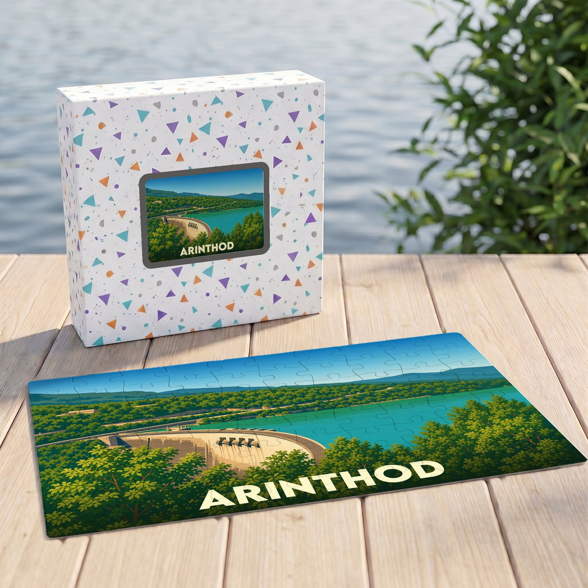 Puzzle souvenir d'Arinthod avec une illustration stylisée représentant son barrage et son paysage verdoyant.
