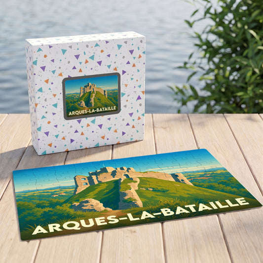 Puzzle souvenir de la ville d'Arques-la-Bataille illustrant les ruines de son château sur une colline verdoyante.