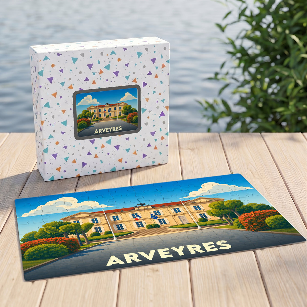 Puzzle souvenir de la ville d'Arveyres présentant une illustration stylisée de son hôtel de ville devant sa boîte assortie.
