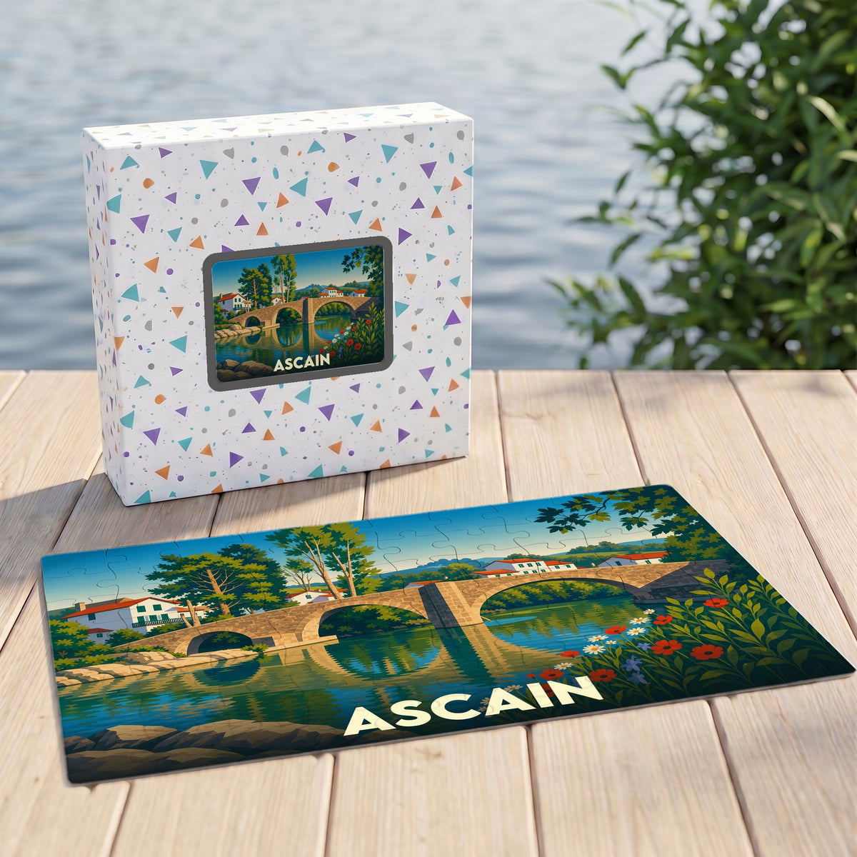 Puzzle souvenir de la ville d'Ascain avec une illustration stylisée d'un pont en pierre.