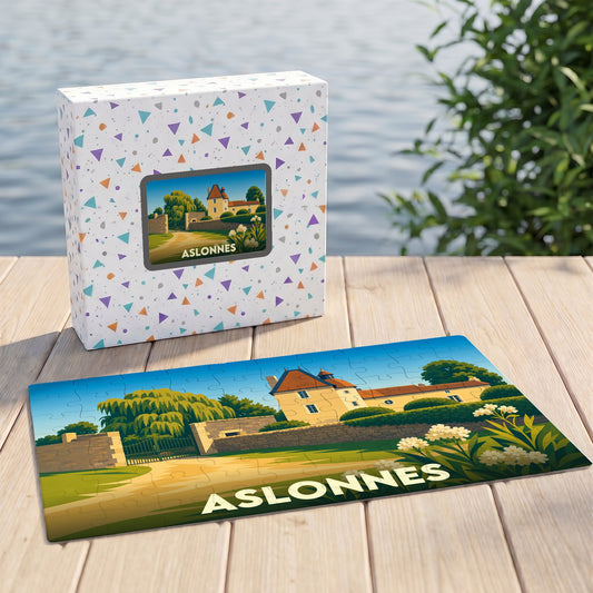 Puzzle souvenir de la ville d'Aslonnes avec son illustration de château sur un plateau en bois devant sa boîte.