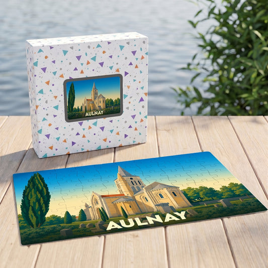 Puzzle souvenir de la ville d'Aulnay représentant son église dans un style illustré, posé à côté de sa boîte.