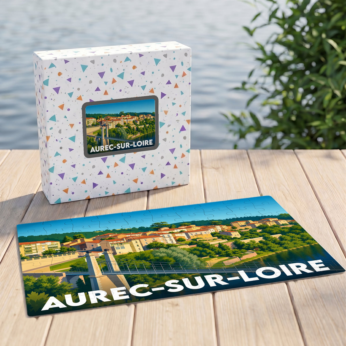 Puzzle souvenir de la ville d'Aurec-sur-Loire avec une illustration stylisée de son pont et de ses maisons en bord de fleuve.