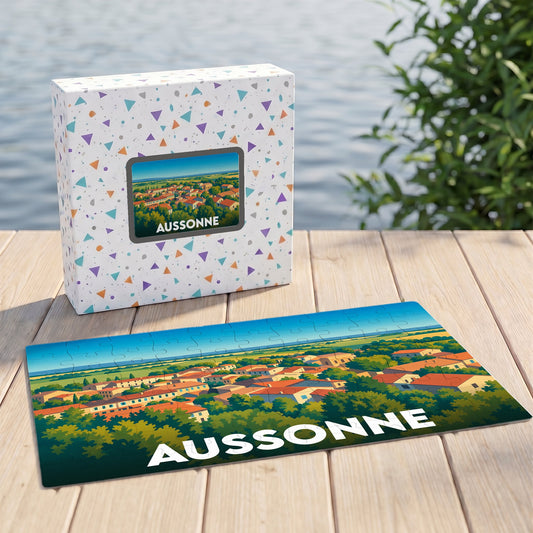 Puzzle souvenir de la ville d'Aussonne présentant une vue panoramique illustrée sur une terrasse en bois.