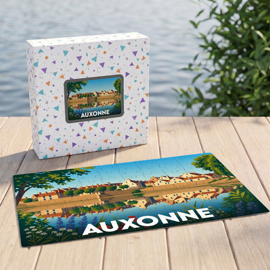 Puzzle souvenir de la ville d'Auxonne avec une illustration stylisée d'un paysage urbain au bord de l'eau.