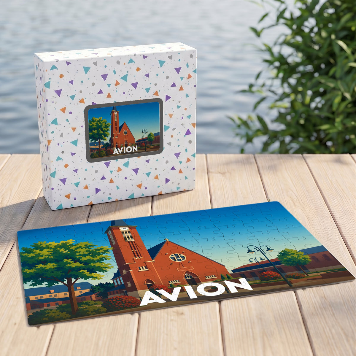 Puzzle souvenir de la ville d'Avion représentant son église dans un style illustré.