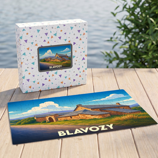 Puzzle souvenir de la ville de Blavozy illustrant un bâtiment en pierre sous un ciel azur.
