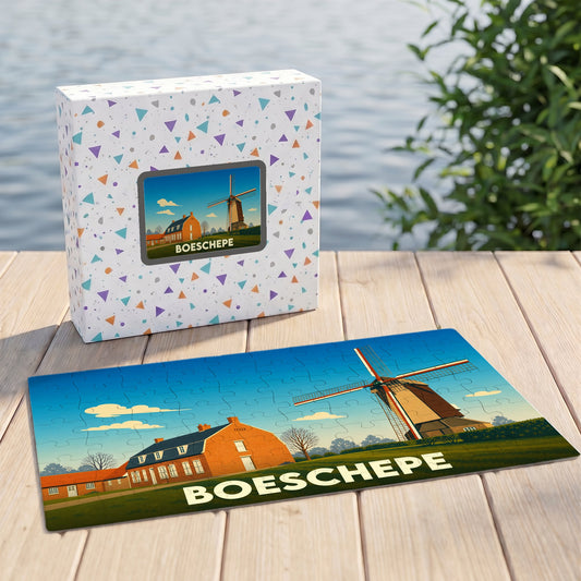 Puzzle souvenir de la ville de Boeschepe avec une illustration stylisée d'un moulin et de maisons traditionnelles.