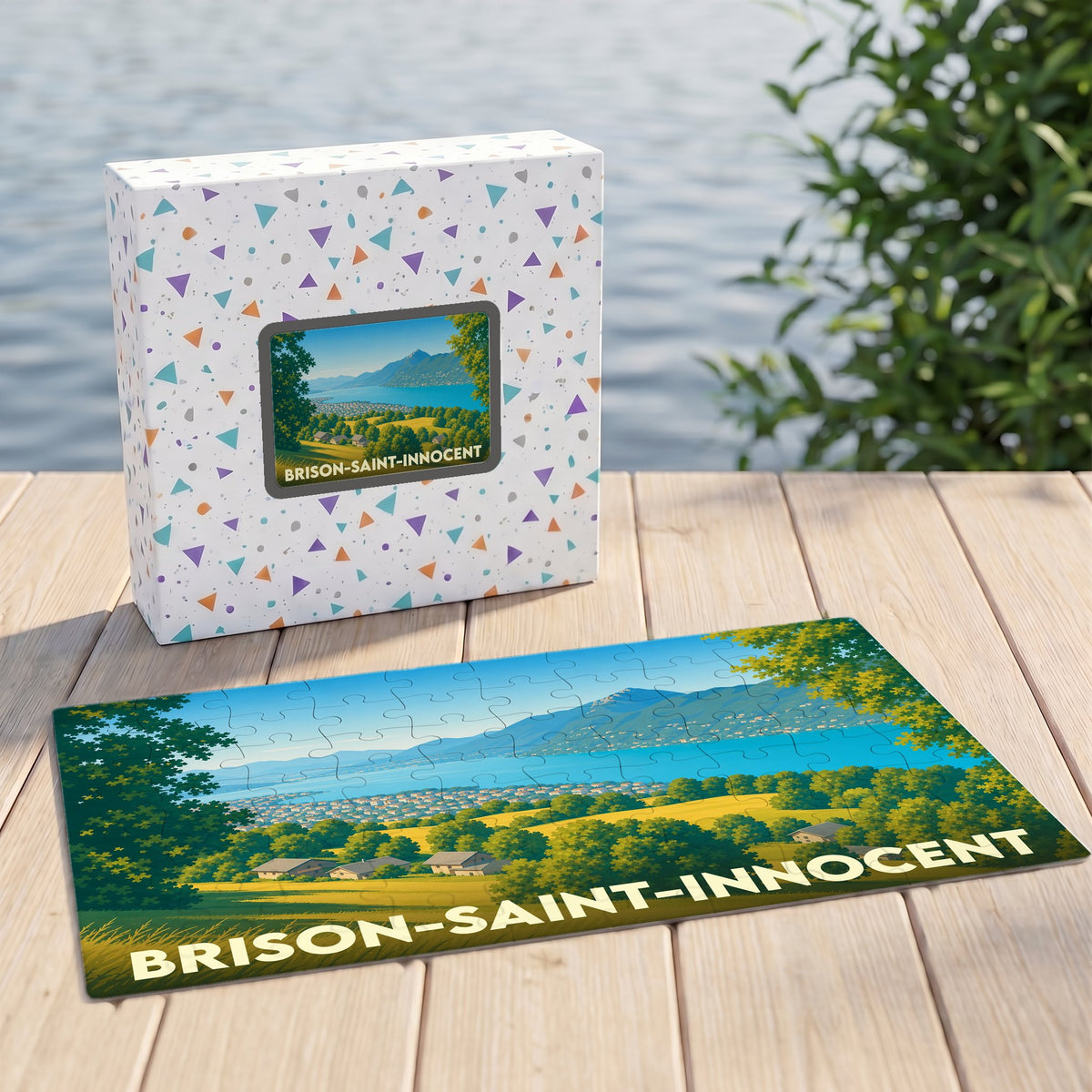 Puzzle souvenir de Brison-Saint-Innocent illustrant un paysage lacustre et montagneux dans un style graphique.