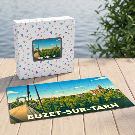 Puzzle souvenir de la ville de Buzet-sur-Tarn avec une illustration stylisée représentant son pont et son église.