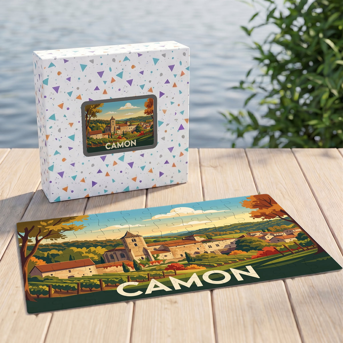 Puzzle souvenir de la ville de Camon avec une illustration stylisée d'un paysage champêtre.