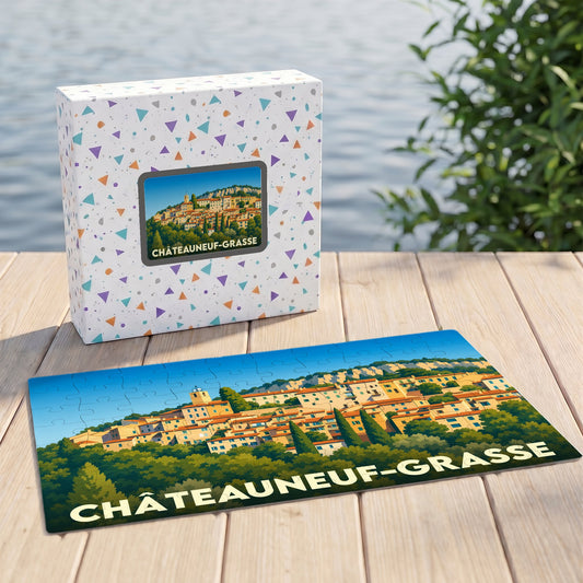 Puzzle souvenir de la ville de Châteauneuf-Grasse avec une illustration stylisée du village et sa boîte assortie.