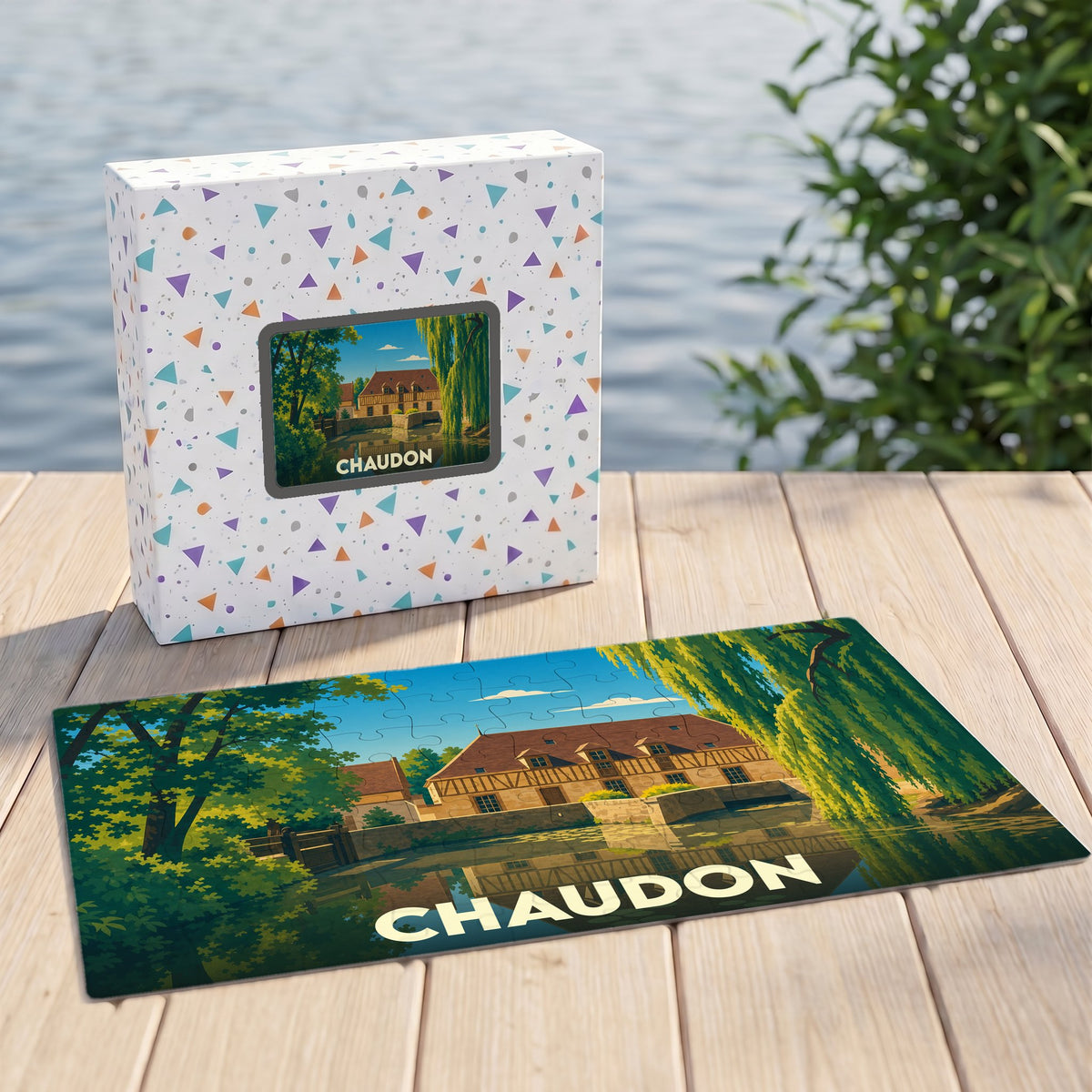 Puzzle souvenir de la ville de Chaudon avec une illustration stylisée d'un moulin au bord de l'eau.