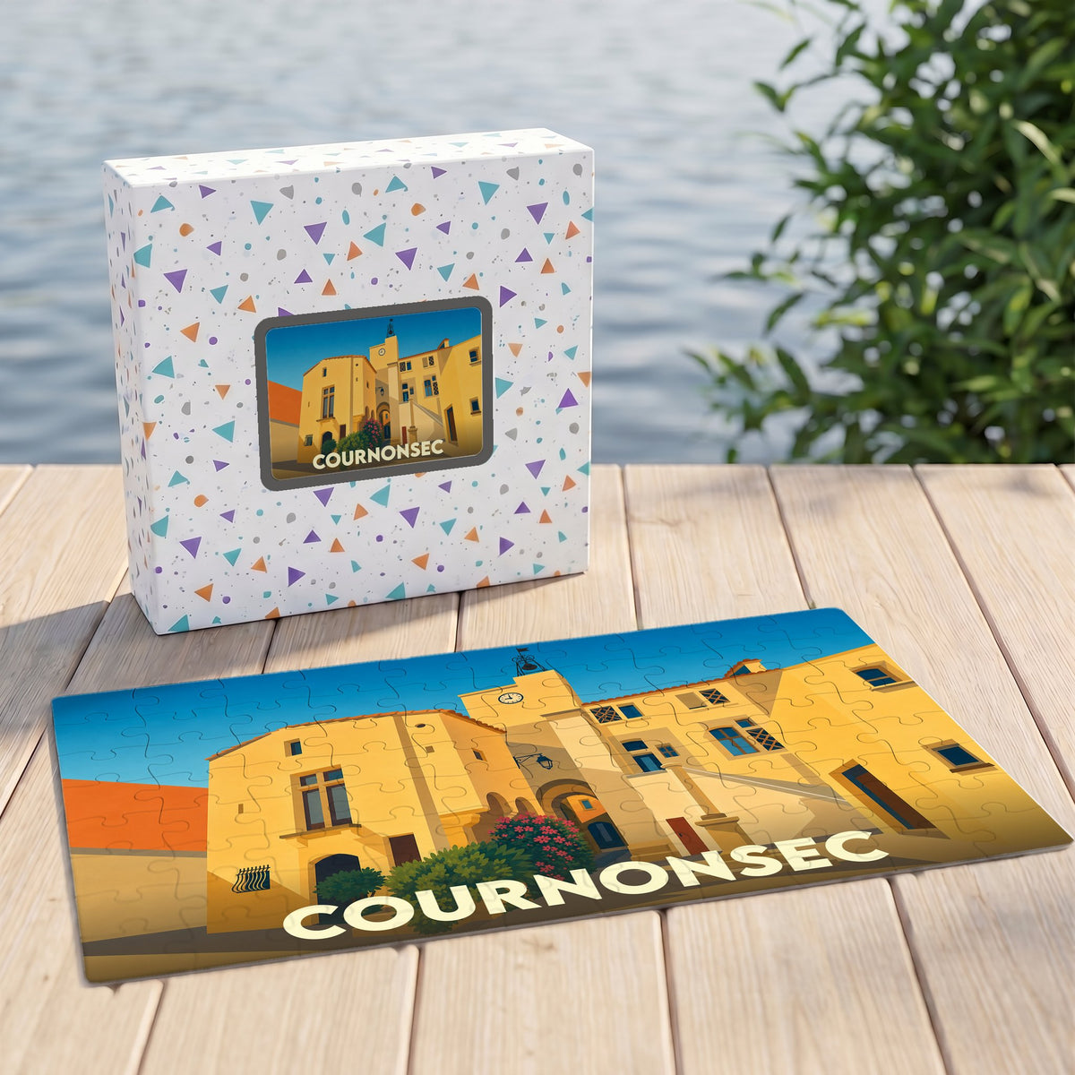 Puzzle souvenir de la ville de Cournonsec illustré d'un paysage urbain stylisé, présenté avec sa boîte décorée.