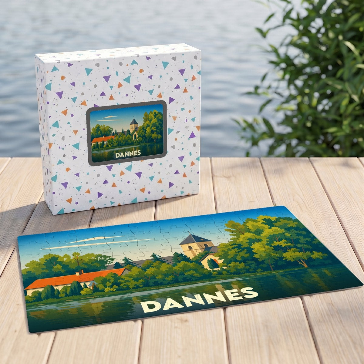 Puzzle souvenir de la ville de Dannes avec une illustration stylisée d'un paysage lacustre.