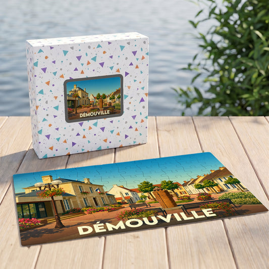 Puzzle souvenir de la ville de Démouville représentant une place ensoleillée et fleurie dans un style illustré.