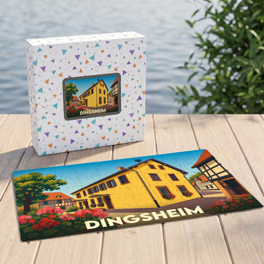 Puzzle souvenir de la ville de Dingsheim représentant une maison alsacienne jaune illustrée.