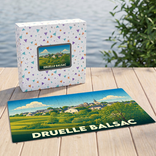 Puzzle souvenir de la commune de Druelle Balsac avec une illustration paysagère stylisée.