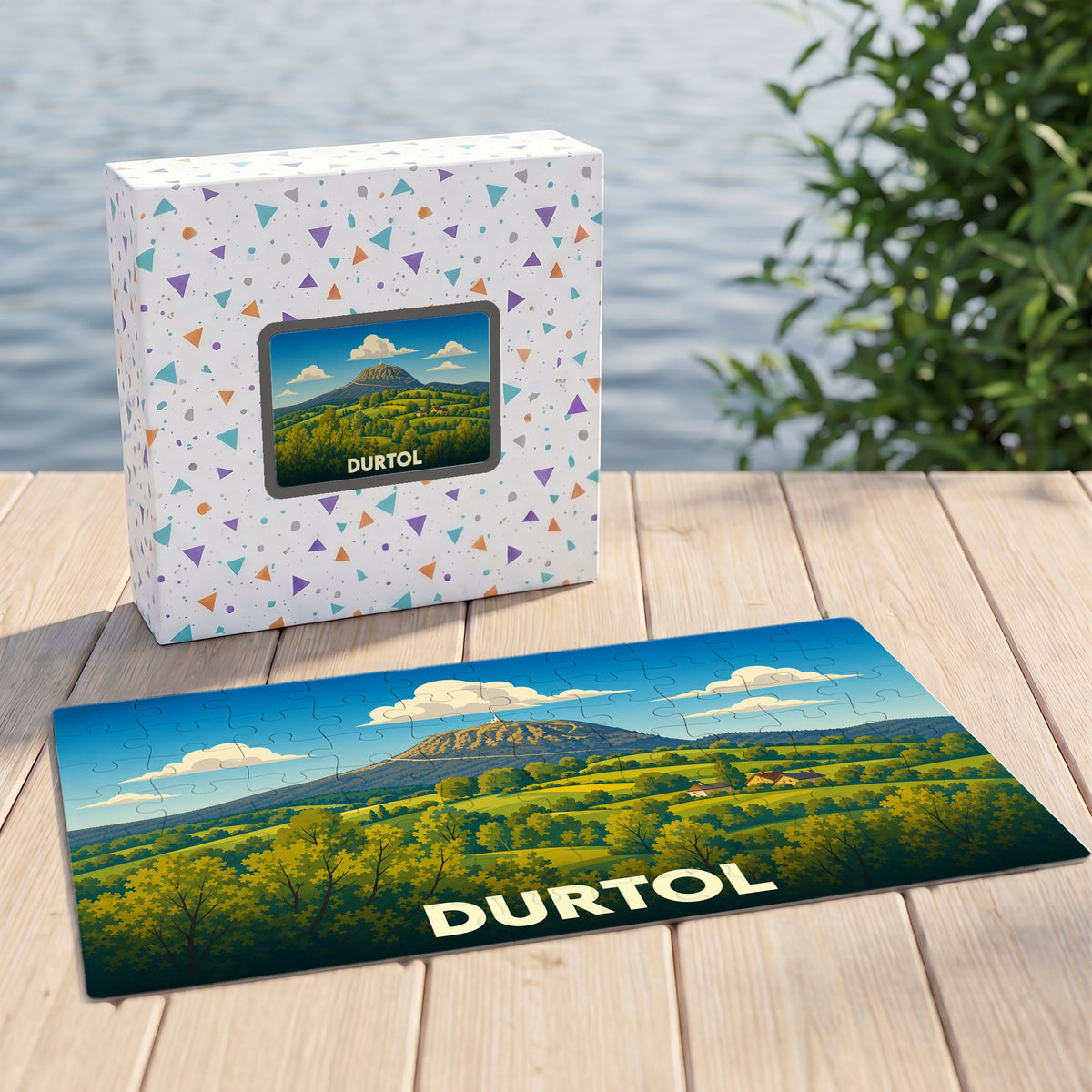 Puzzle souvenir de la ville de Durtol avec une illustration stylisée d'un paysage de collines verdoyantes.