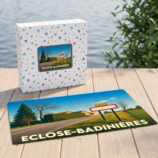 Puzzle souvenir de la commune d'Eclose-Badinières avec son illustration stylisée et sa boîte assortie.