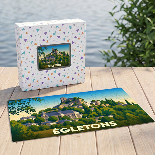 Puzzle souvenir de la ville d'Égletons représentant un paysage illustré avec son château et son église.